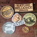 Collection of 'Nature Reliance' branded stickers on a wooden background