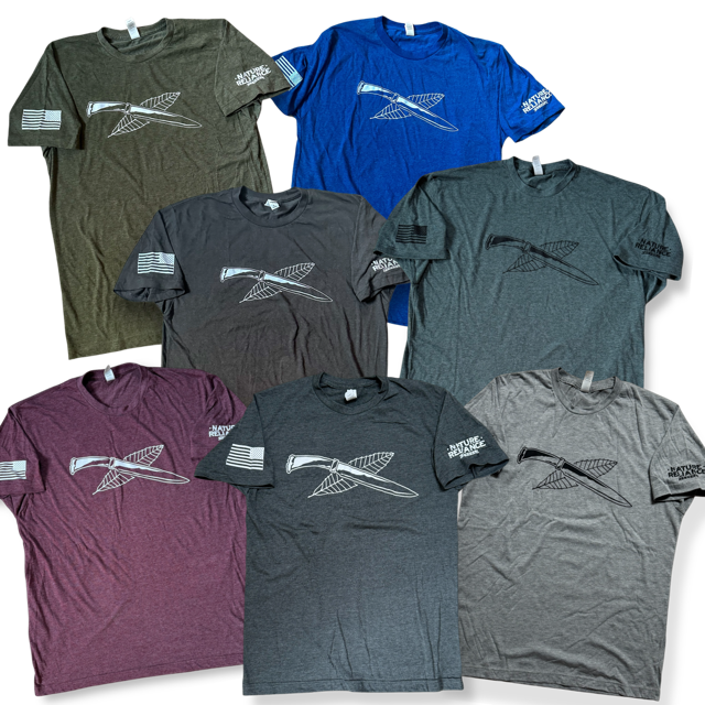 All Colors Together – A collection of Nature Reliance School t-shirts in seven stylish variations, designed for adventure and everyday wear.