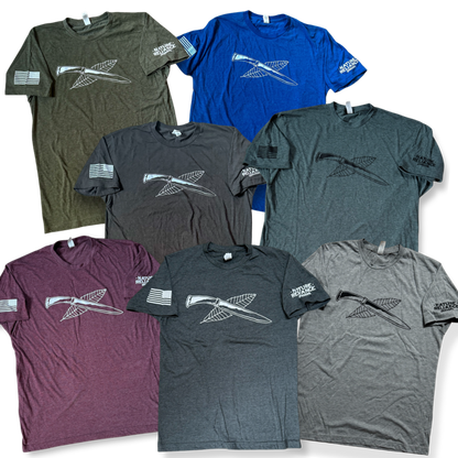 All Colors Together – A collection of Nature Reliance School t-shirts in seven stylish variations, designed for adventure and everyday wear.